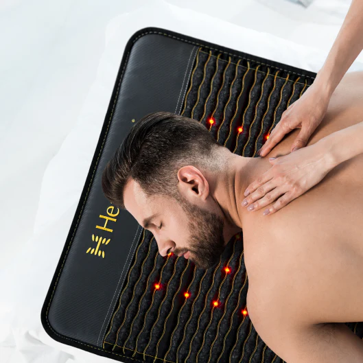 Man getting a massage while lying on a HealthyLine Jet Mat 7428